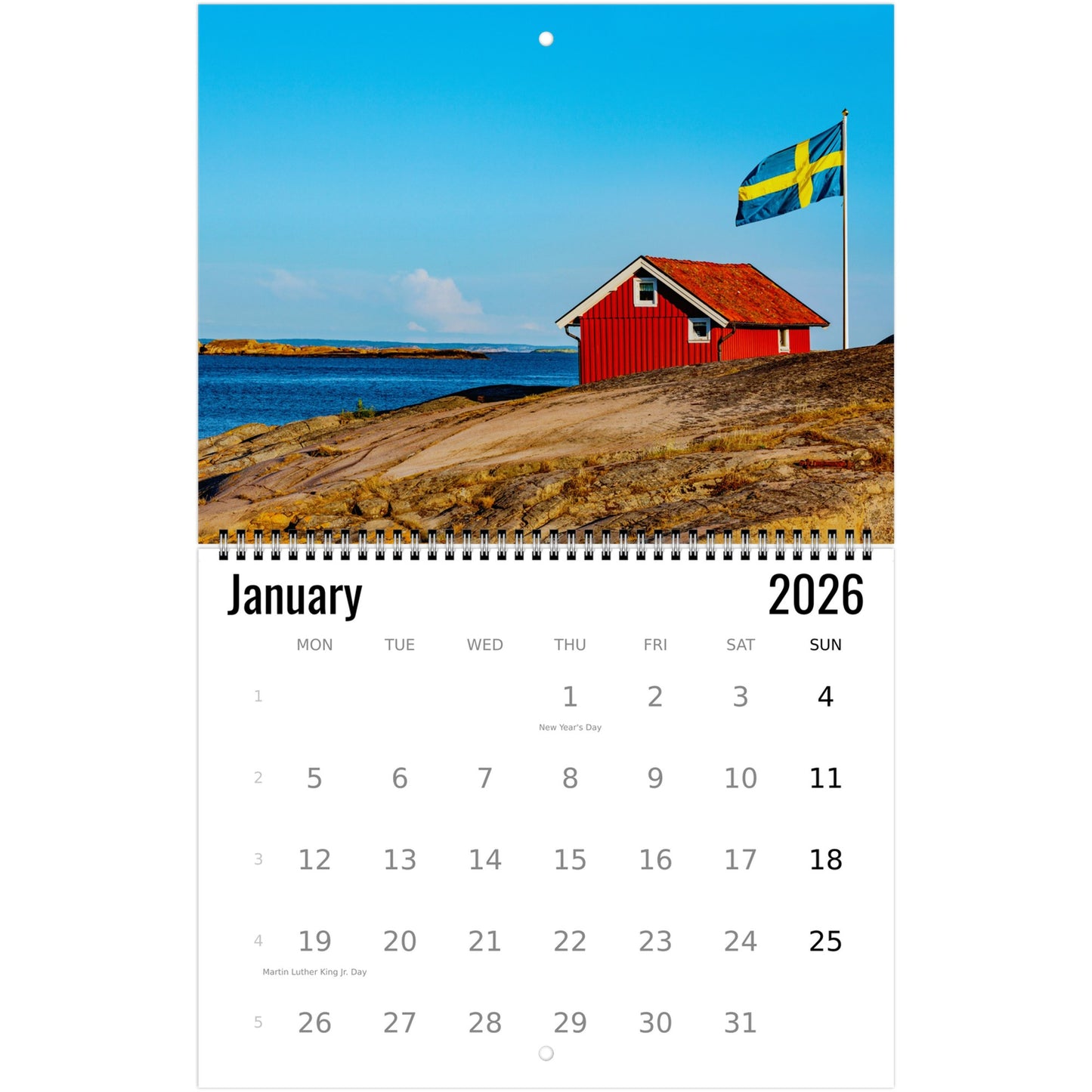 Calendar for January 2026 with a scenic red house and flag on a hillside.